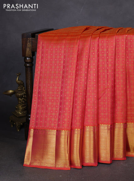 Pure kanchipuram silk saree dual shade of pinkish orange with allover zari checks & buttas and zari woven border
