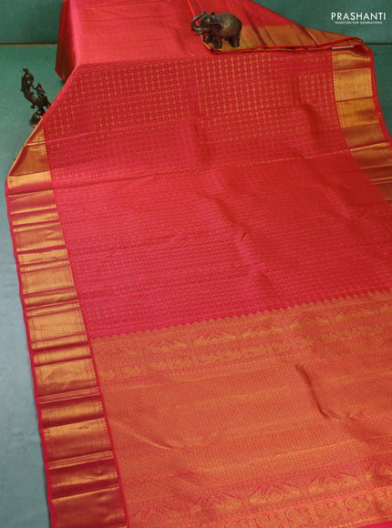 Pure kanchipuram silk saree dual shade of pinkish orange with allover zari checks & buttas and zari woven border