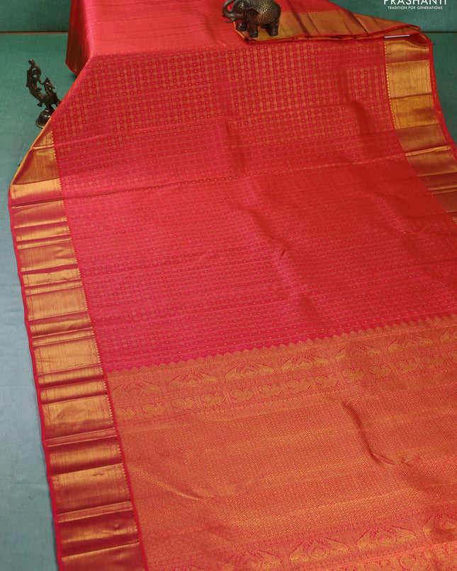 Pure kanchipuram silk saree dual shade of pinkish orange with allover zari checks & buttas and zari woven border