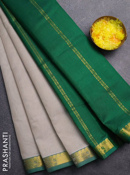 Silk cotton saree grey and green with plain body and zari woven border