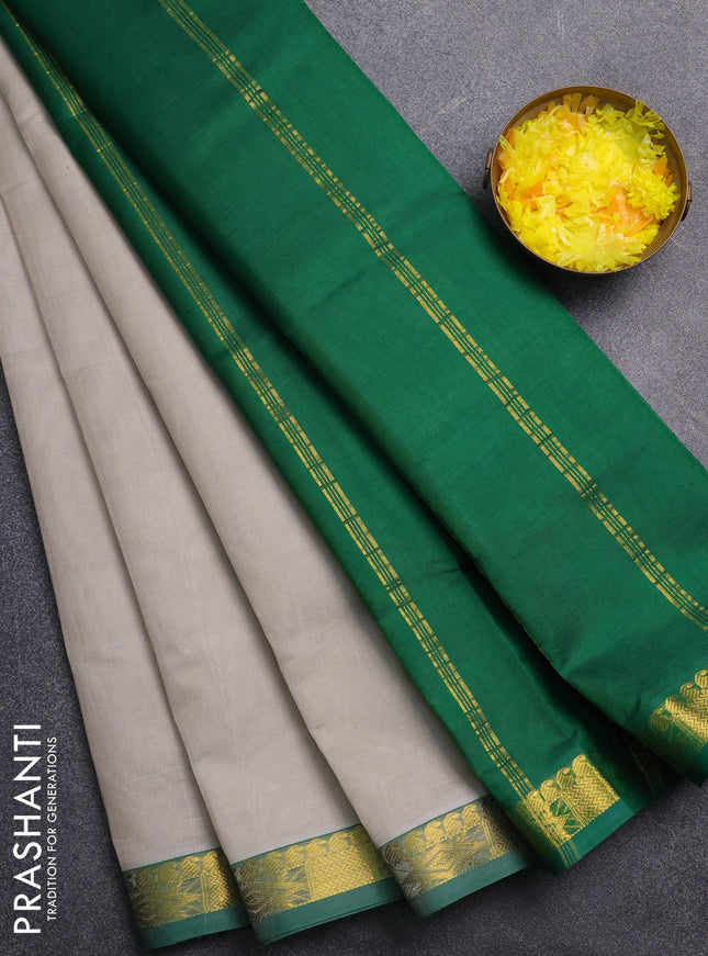 Silk cotton saree grey and green with plain body and zari woven border