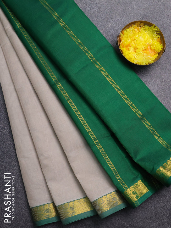 Silk cotton saree grey and green with plain body and zari woven border