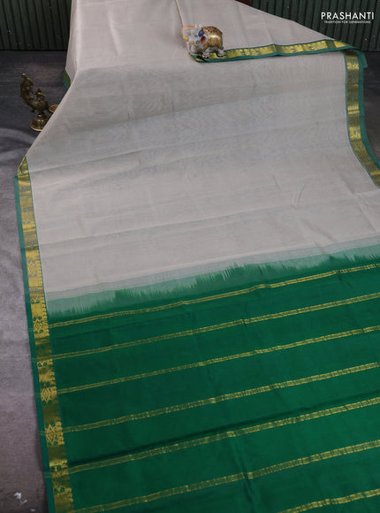 Silk cotton saree grey and green with plain body and zari woven border