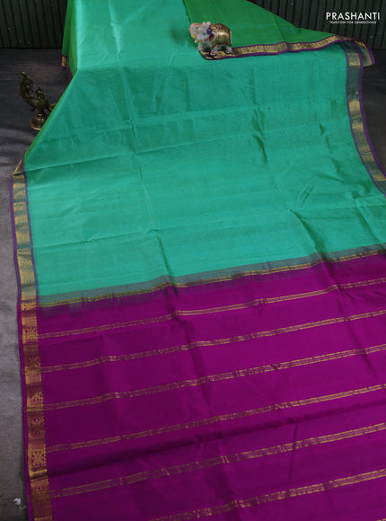 Silk cotton saree green and purple with plain body and zari woven border