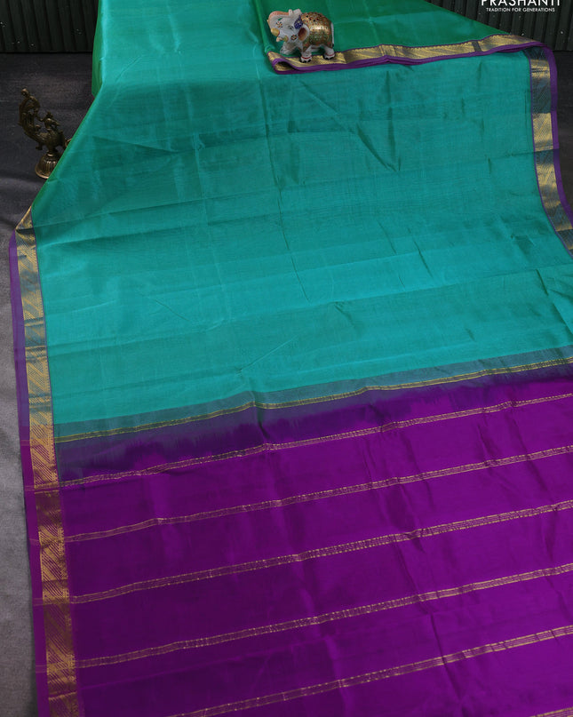 Silk cotton saree teal green and purple with plain body and zari woven border