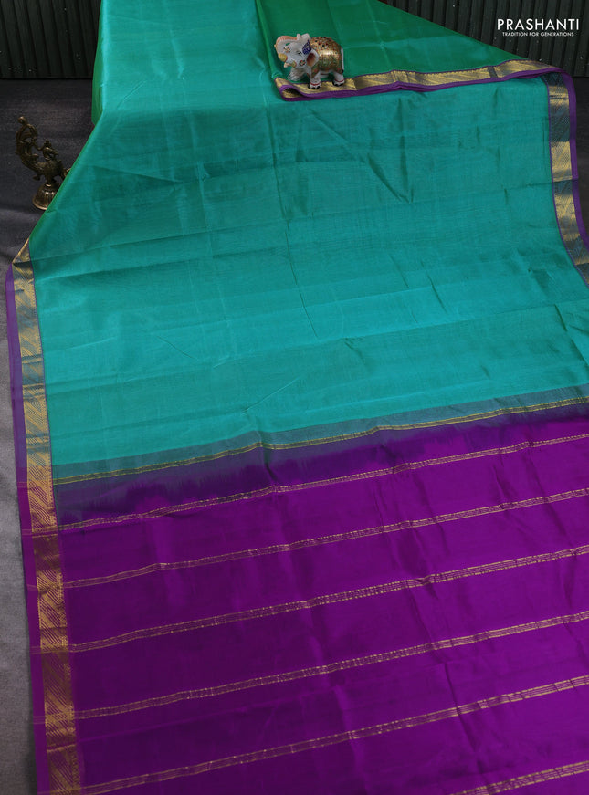 Silk cotton saree teal green and purple with plain body and zari woven border