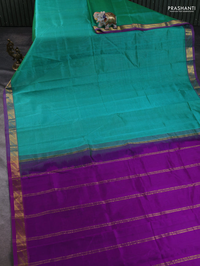 Silk cotton saree teal green and purple with plain body and zari woven border