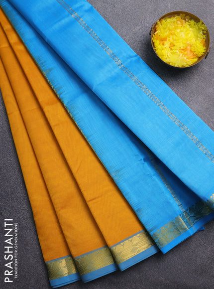 Silk cotton saree mustard yellow and light blue with plain body and zari woven border