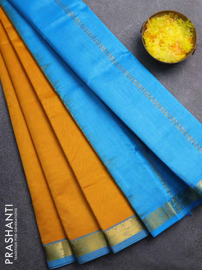 Silk cotton saree mustard yellow and light blue with plain body and zari woven border
