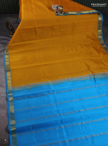 Silk cotton saree mustard yellow and light blue with plain body and zari woven border