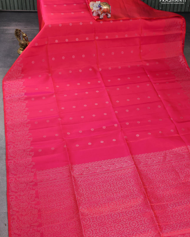 Pure soft silk saree dual shade of pinkish orange with silver zari woven buttas and rich silver zari woven border
