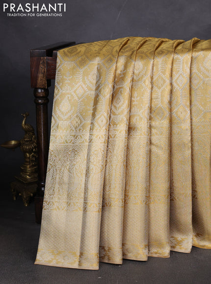 Pure kanchipuram tissue silk saree gold with allover zari woven brocade weaves and long zari woven border