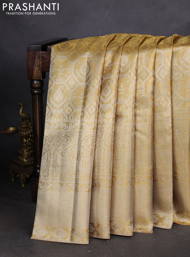 Pure kanchipuram tissue silk saree gold with allover zari woven brocade weaves and long zari woven border