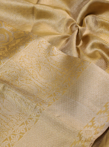 Pure kanchipuram tissue silk saree gold with allover zari woven brocade weaves and long zari woven border