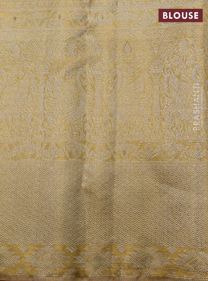 Pure kanchipuram tissue silk saree gold with allover zari woven brocade weaves and long zari woven border
