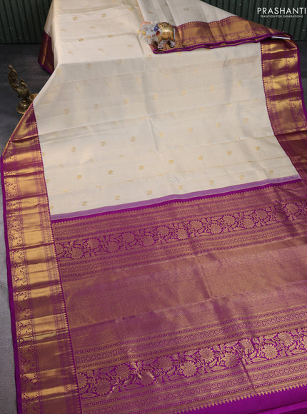 Pure kanchipuram silk saree cream and purple with allover zari checks & butta weaves and rich zari woven border