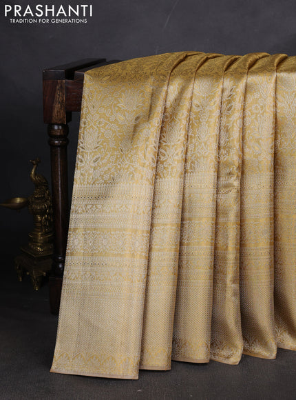 Pure kanchipuram tissue silk saree gold with allover zari woven brocade weaves and long zari woven border