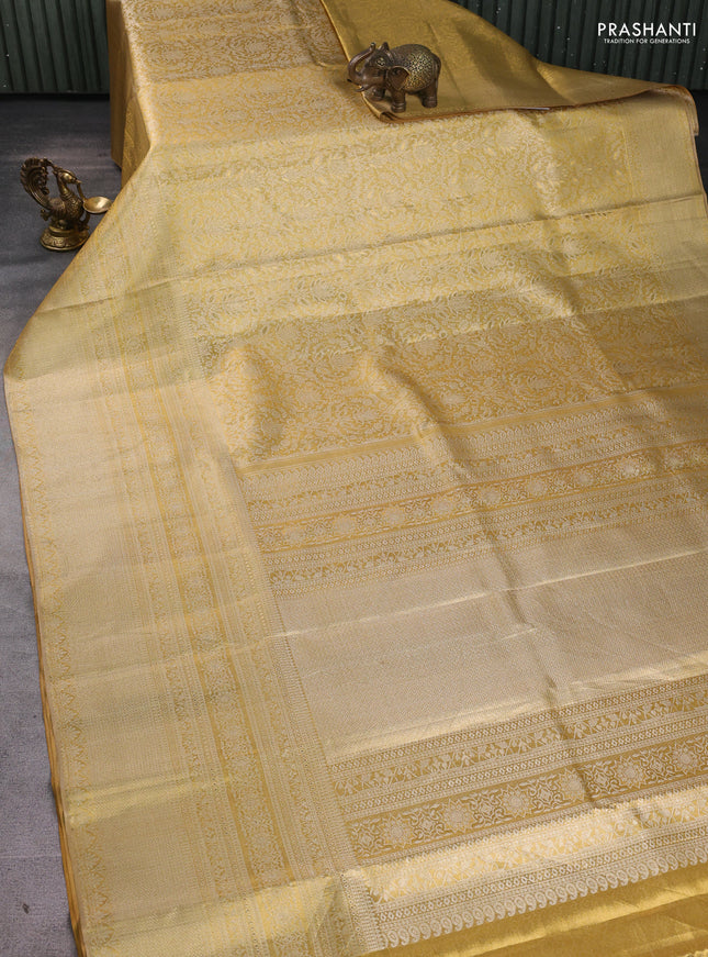Pure kanchipuram tissue silk saree gold with allover zari woven brocade weaves and long zari woven border