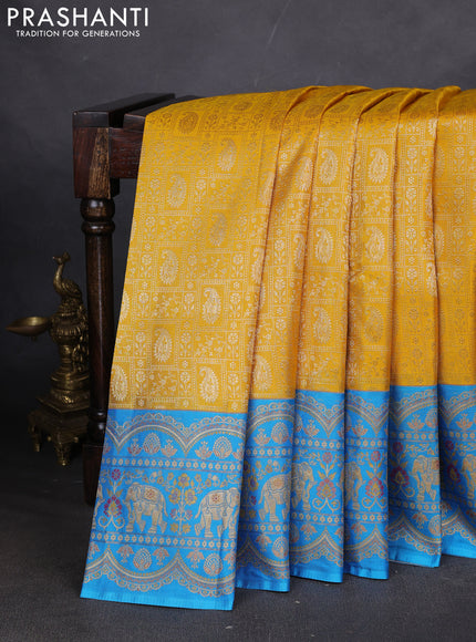 Pure kanchipuram silk saree yellow and cs blue with allover zari woven brocade weaves and long zari woven elephant border