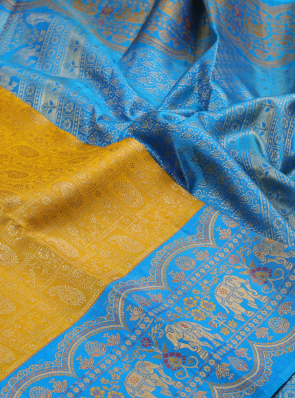 Pure kanchipuram silk saree yellow and cs blue with allover zari woven brocade weaves and long zari woven elephant border