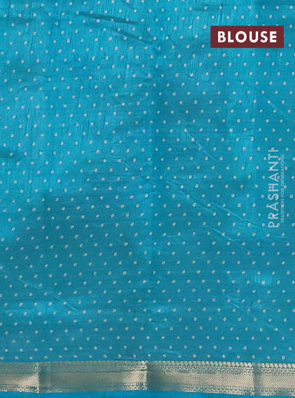 Semi raw silk saree teal blue with allover geometric prints and zari woven border