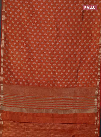 Semi raw silk saree rustic orange with allover butta prints and zari woven border