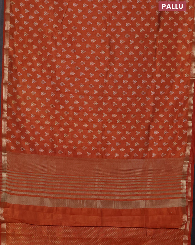 Semi raw silk saree rustic orange with allover butta prints and zari woven border