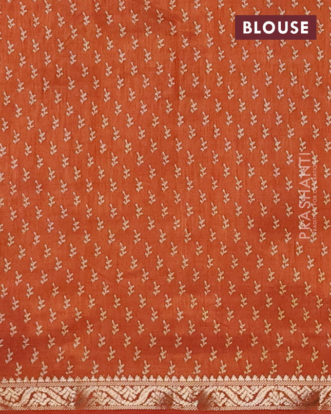 Semi raw silk saree rustic orange with allover butta prints and zari woven border