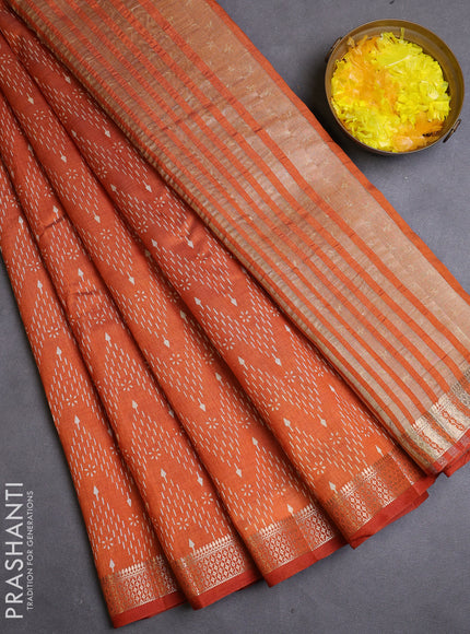 Semi raw silk saree rustic orange with allover zig zag prints and zari woven border