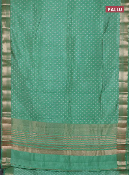 Semi raw silk saree teal green with allover butta prints and zari woven border