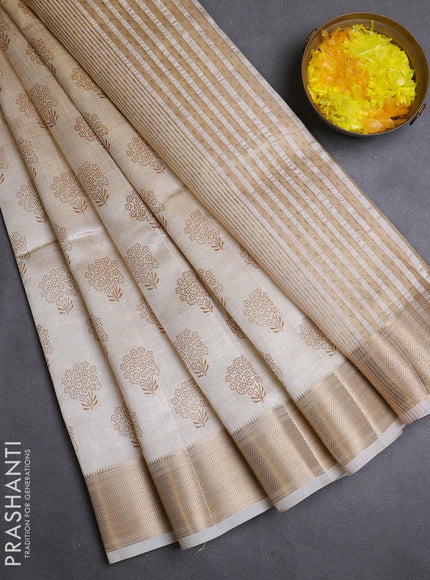 Semi raw silk saree cream with allover butta prints and zari woven border