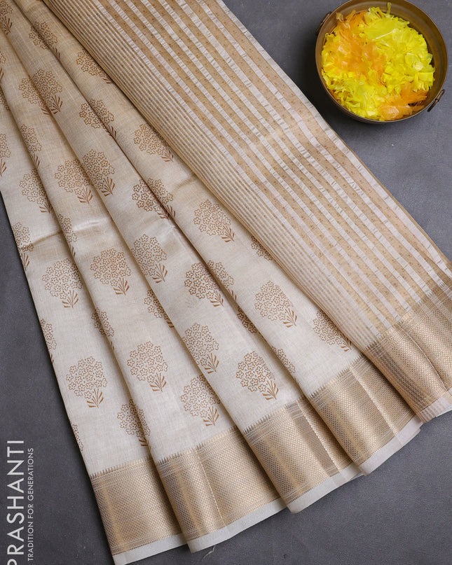 Semi raw silk saree cream with allover butta prints and zari woven border