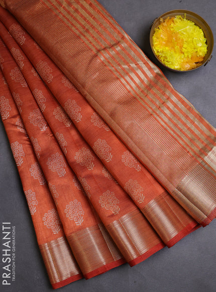 Semi raw silk saree rustic orange with allover butta prints and zari woven border