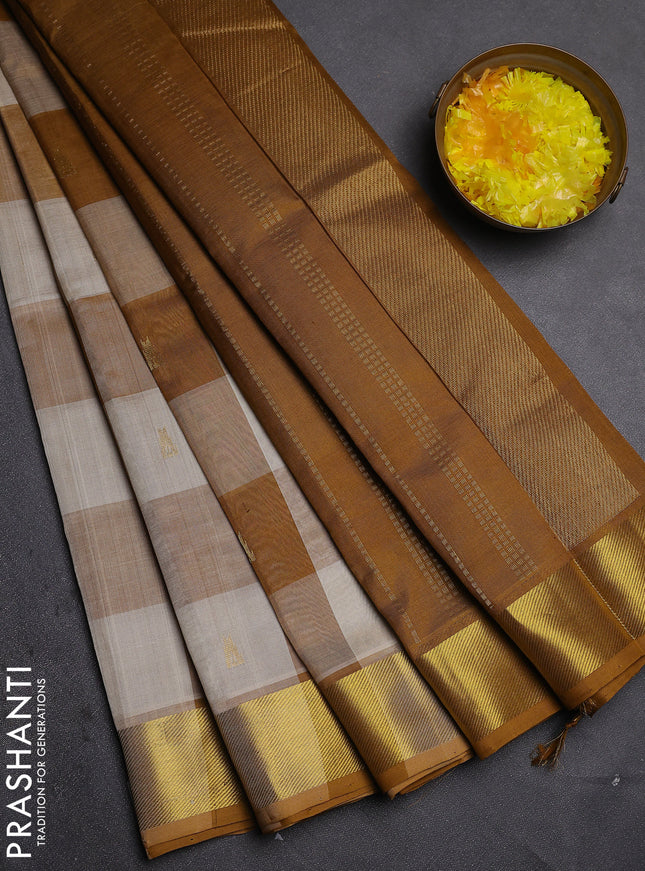 Silk cotton saree cream and dark mustard with allover paalum pazhamum checks & zari buttas and zari woven border