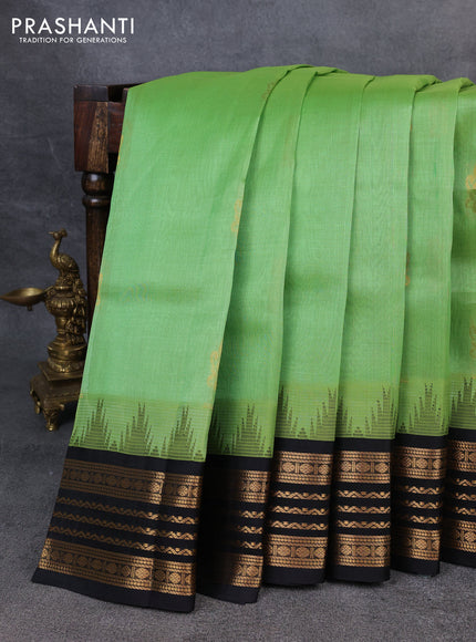 Kuppadam silk cotton saree pastel green and black with zari woven buttas and temple design zari woven border