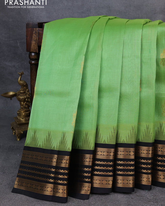 Kuppadam silk cotton saree pastel green and black with zari woven buttas and temple design zari woven border