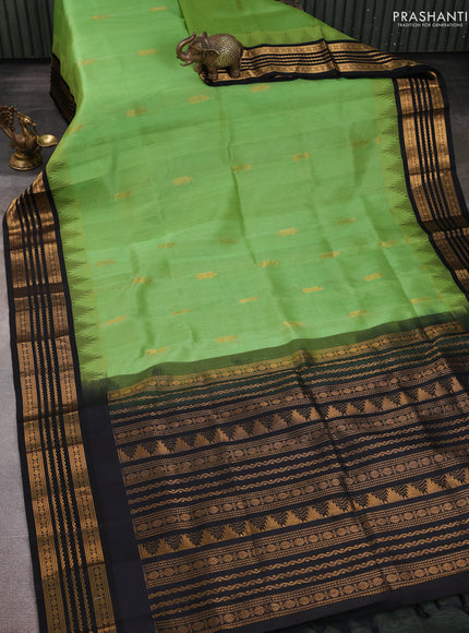 Kuppadam silk cotton saree pastel green and black with zari woven buttas and temple design zari woven border