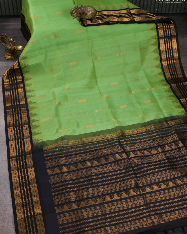 Kuppadam silk cotton saree pastel green and black with zari woven buttas and temple design zari woven border