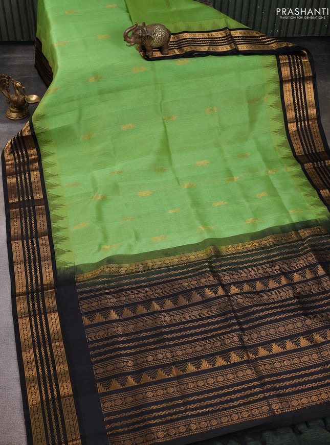 Kuppadam silk cotton saree pastel green and black with zari woven buttas and temple design zari woven border