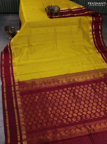 Kuppadam silk cotton saree yellow and maroon with allover zari checks & buttas and rettapet zari woven border