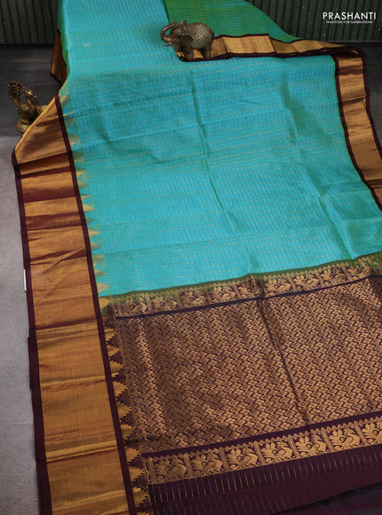 Kuppadam silk cotton saree teal blue and deep maroon with allover zari checks & lakshadeepam weaves and temple design zari checked border