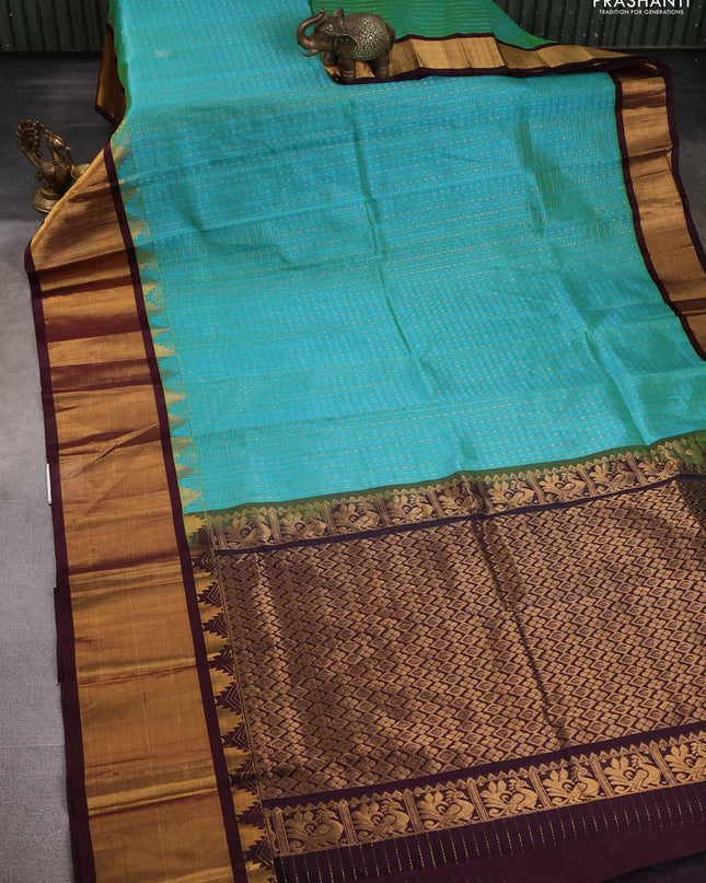 Kuppadam silk cotton saree teal blue and deep maroon with allover zari checks & lakshadeepam weaves and temple design zari checked border