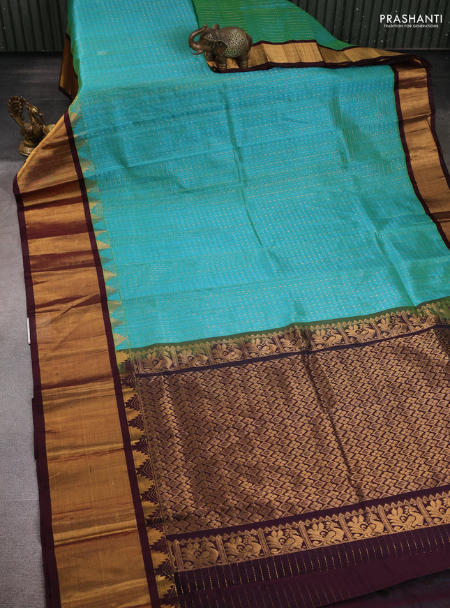 Kuppadam silk cotton saree teal blue and deep maroon with allover zari checks & lakshadeepam weaves and temple design zari checked border