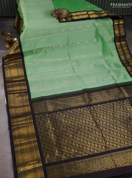 Silk Cotton saree pastel green and black with zari woven buttas and zari woven border