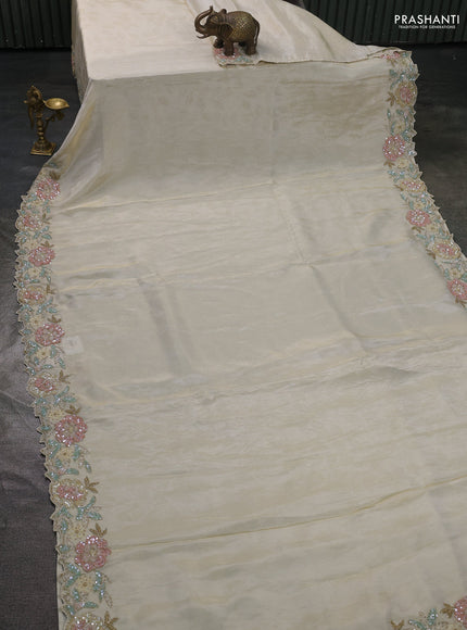 Tissue saree cream with plain body and embroidery border