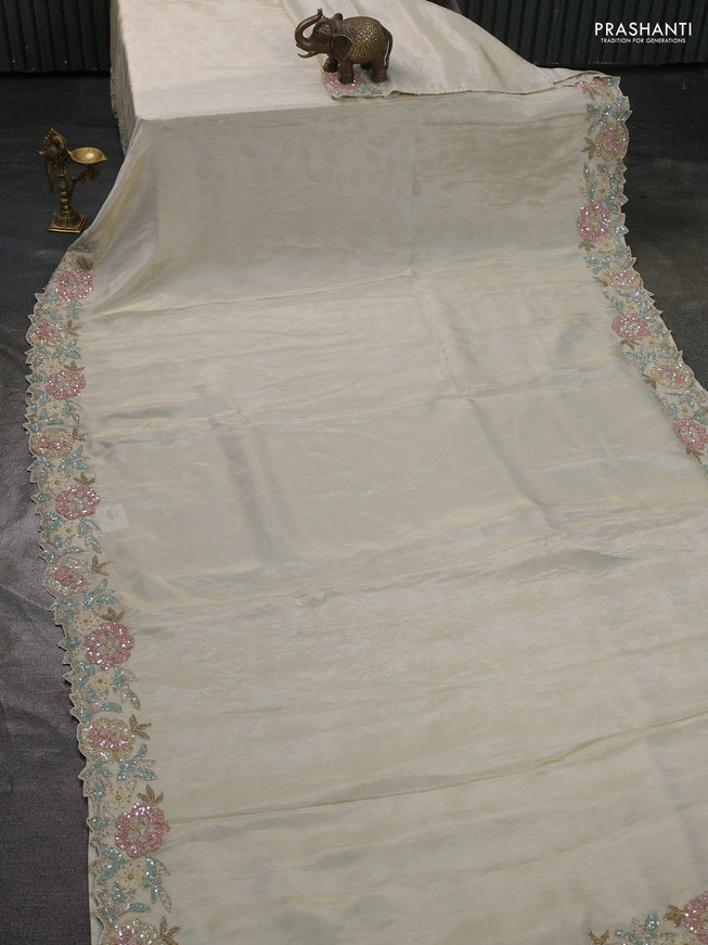 Tissue saree cream with plain body and embroidery border