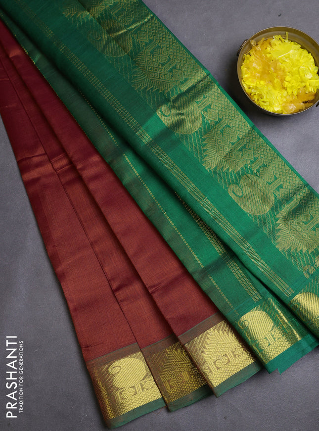 Silk cotton saree rust and green with plain body and zari woven border