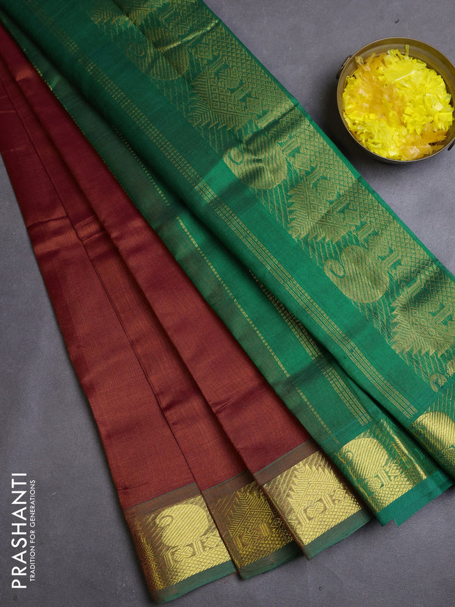 Silk cotton saree rust and green with plain body and zari woven border