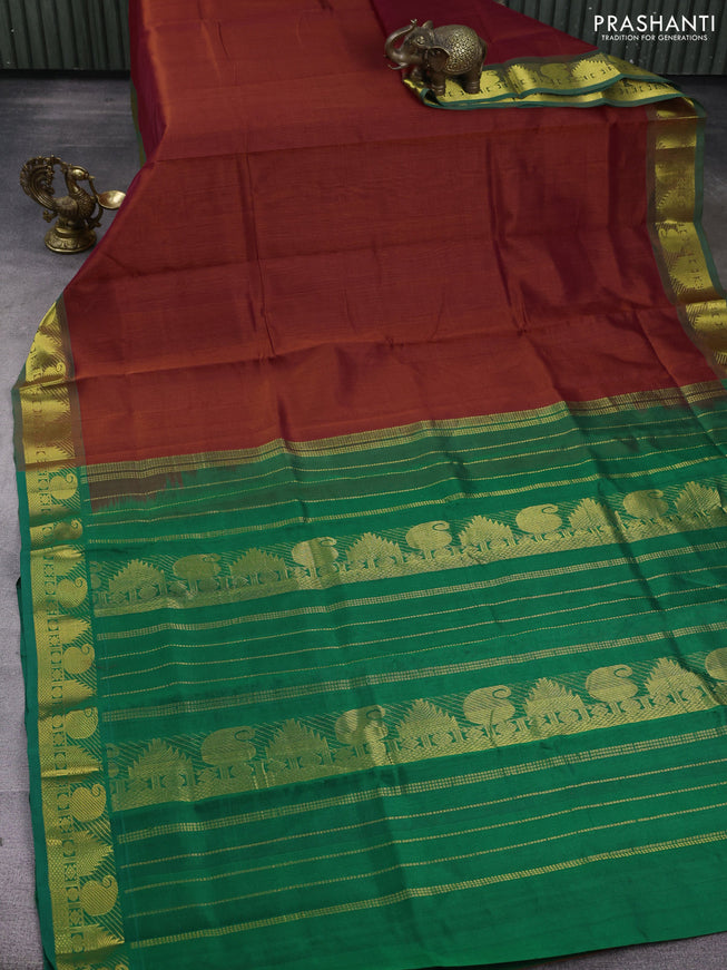 Silk cotton saree rust and green with plain body and zari woven border