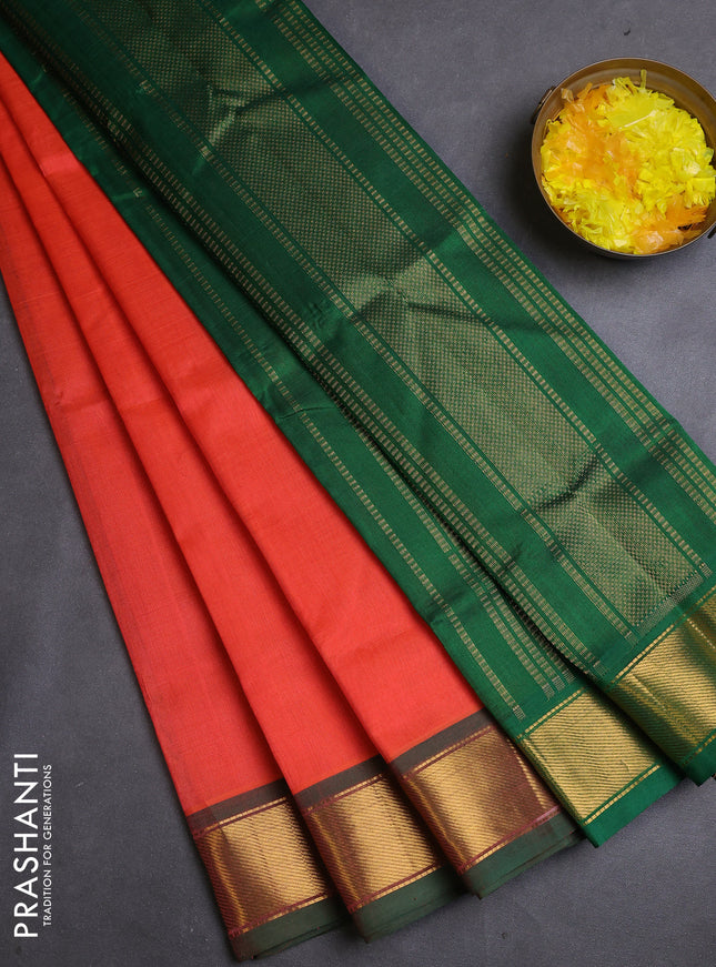 Silk cotton saree orange and green with plain body and zari woven border